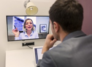 Businessman on video conference with her colleague in office job
